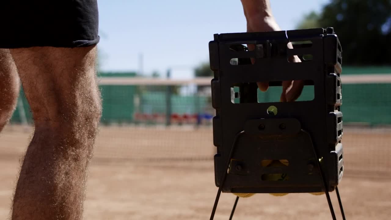 Stock Video A Man Takes A Tennis Ball Out Of The Basket Live Wallpaper For PC