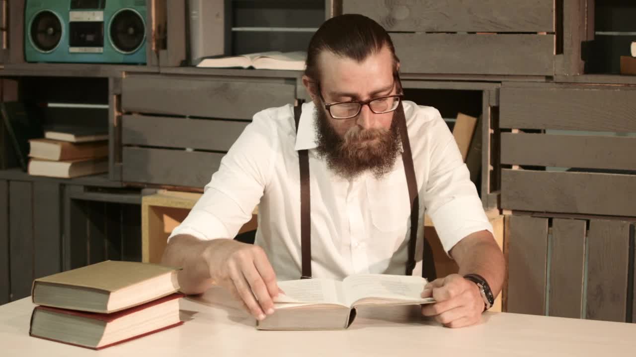 Stock Video A Man Is Reading A Book On The Table Live Wallpaper For PC