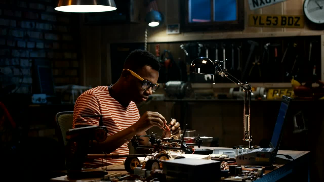 Stock Video A Man In Glasses Is Repairing A Drone Live Wallpaper For PC