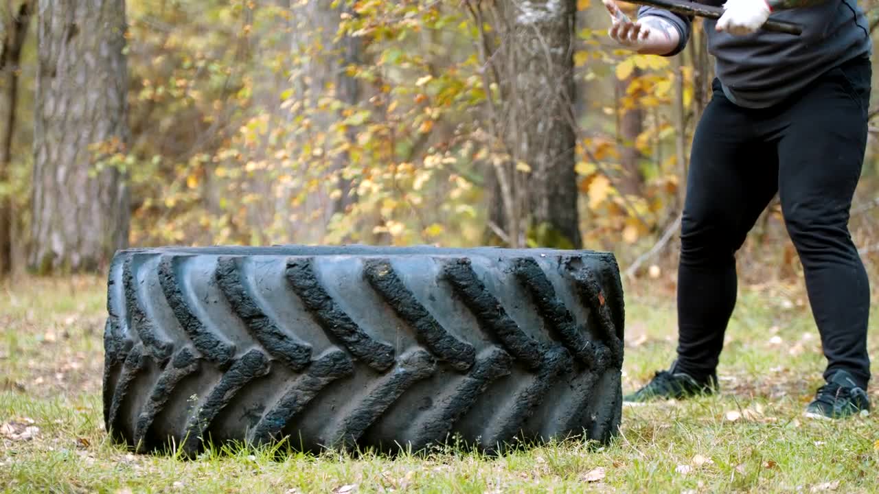 Stock Video A Man Hitting A Tire With A Mallet Live Wallpaper For PC