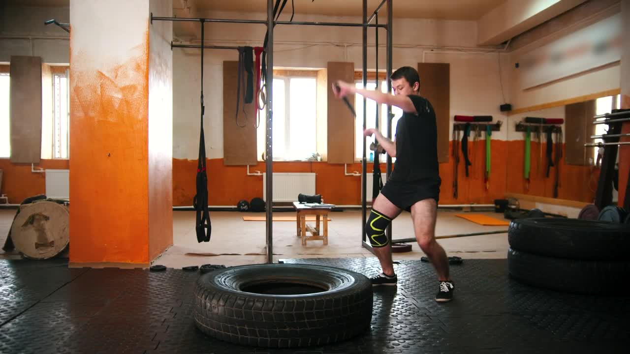 Stock Video A Man Hitting A Tire With A Mallet In The Live Wallpaper For PC