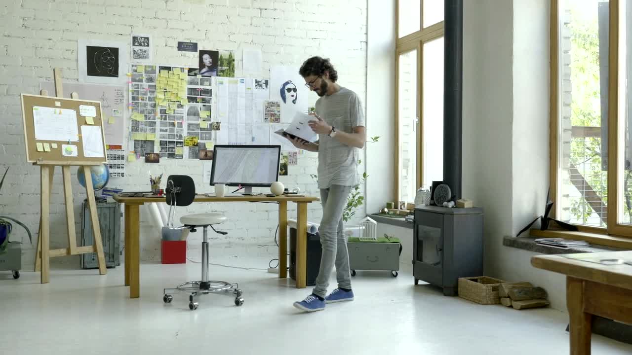 Stock Video A Man Checking His Notes In The Studio Live Wallpaper For PC