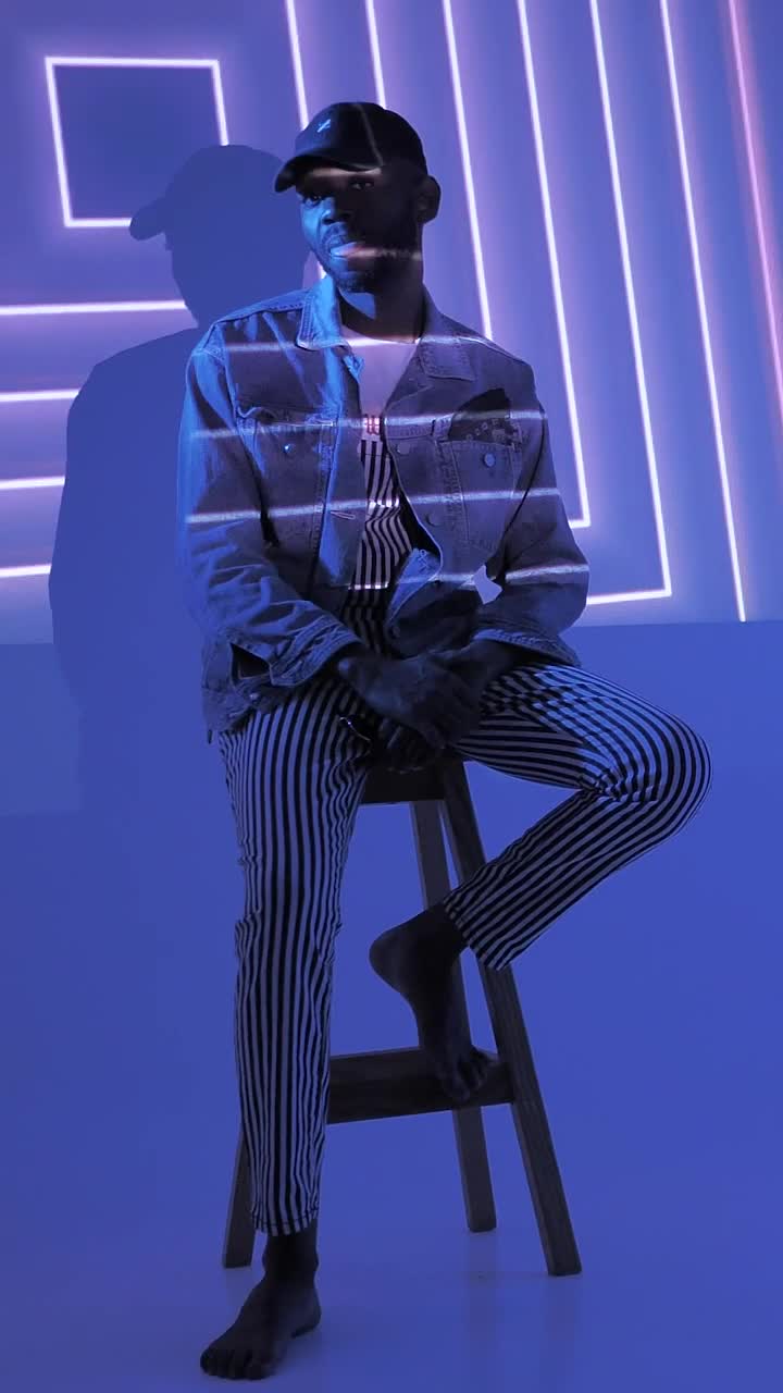 Stock Video A Hipster Sitting On A Chair Under Lights Live Wallpaper For PC