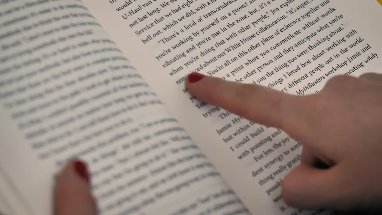 Stock Video A Girls Hand With A Book Following The Reading With Live Wallpaper For PC