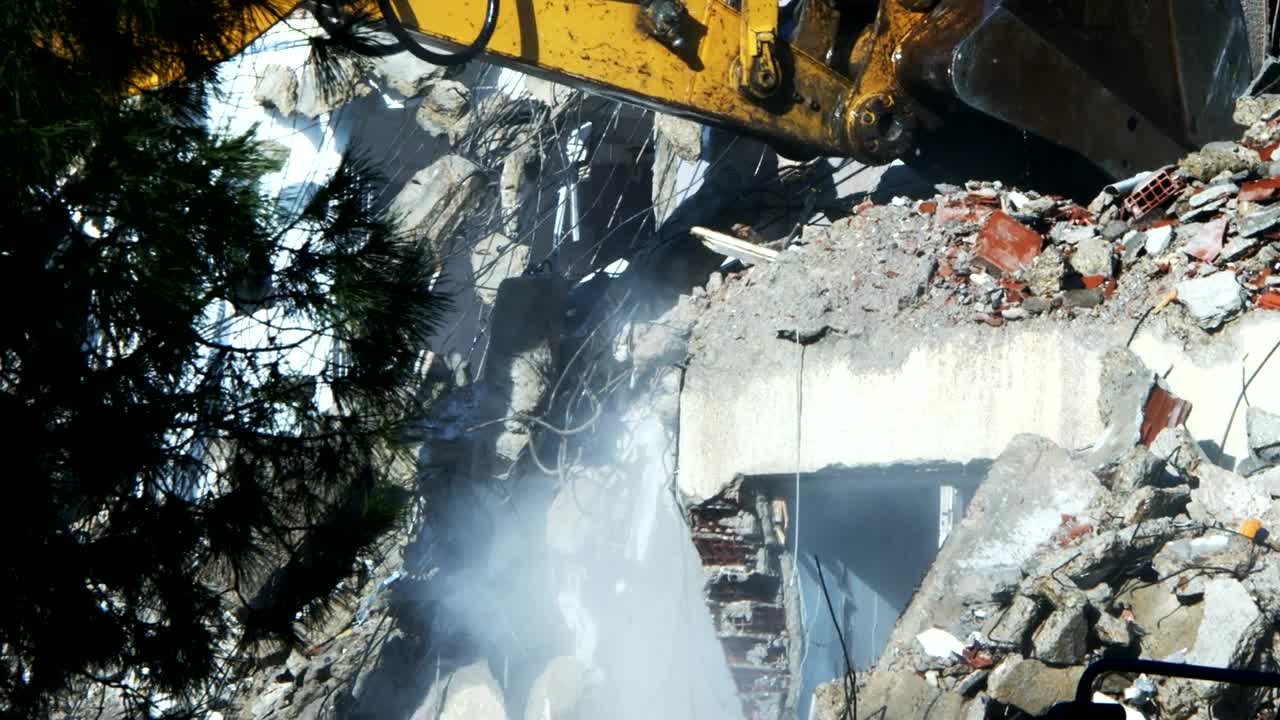 Stock Video Bulldozer Cleaning Debris From A Ruined Building Live Wallpaper For PC