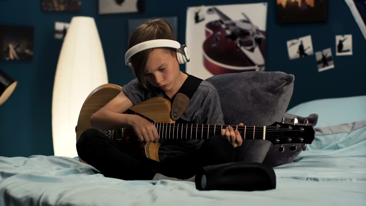 Stock Video Boy With Headphones Playing The Guitar In The Room Live Wallpaper For PC