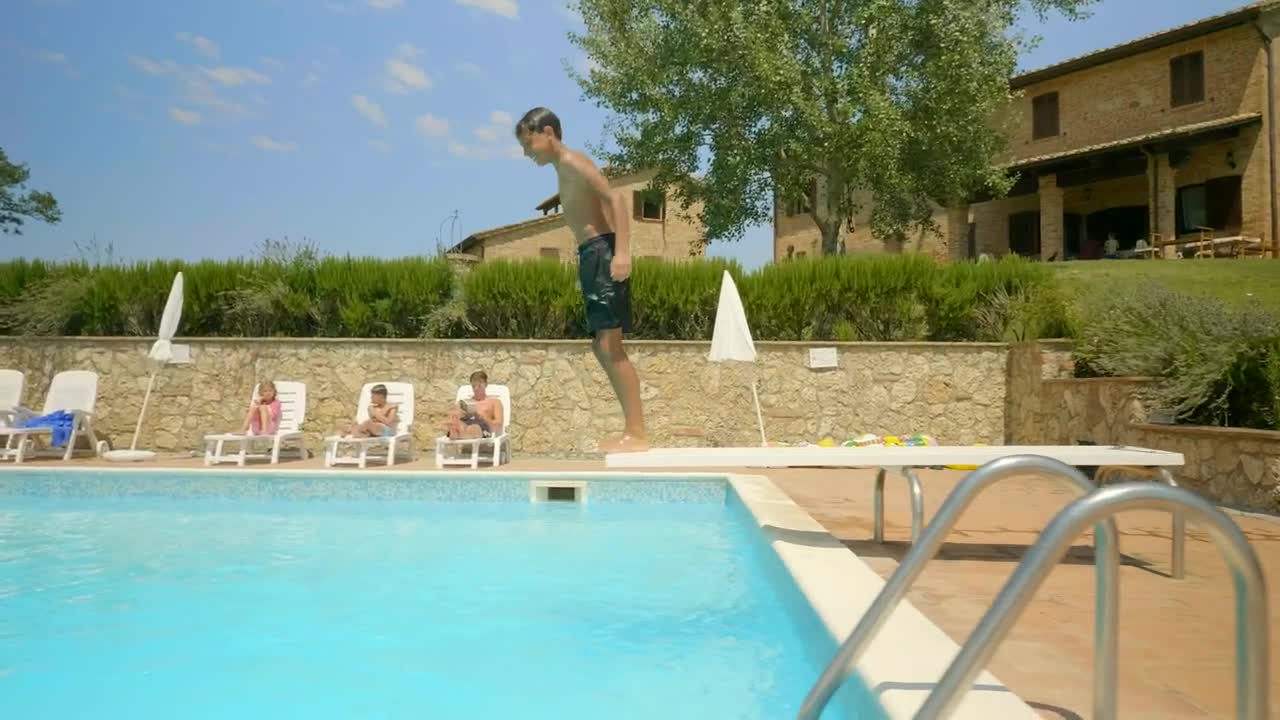 Stock Video Boy Swimming In An Outdoor Pool On A Sunny Day Live Wallpaper For PC
