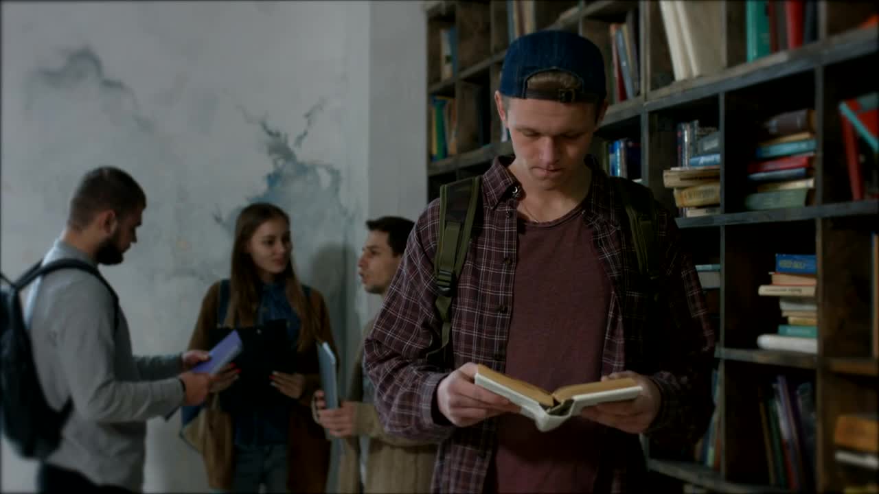 Stock Video Boy Reading A Book In A Library Live Wallpaper For PC