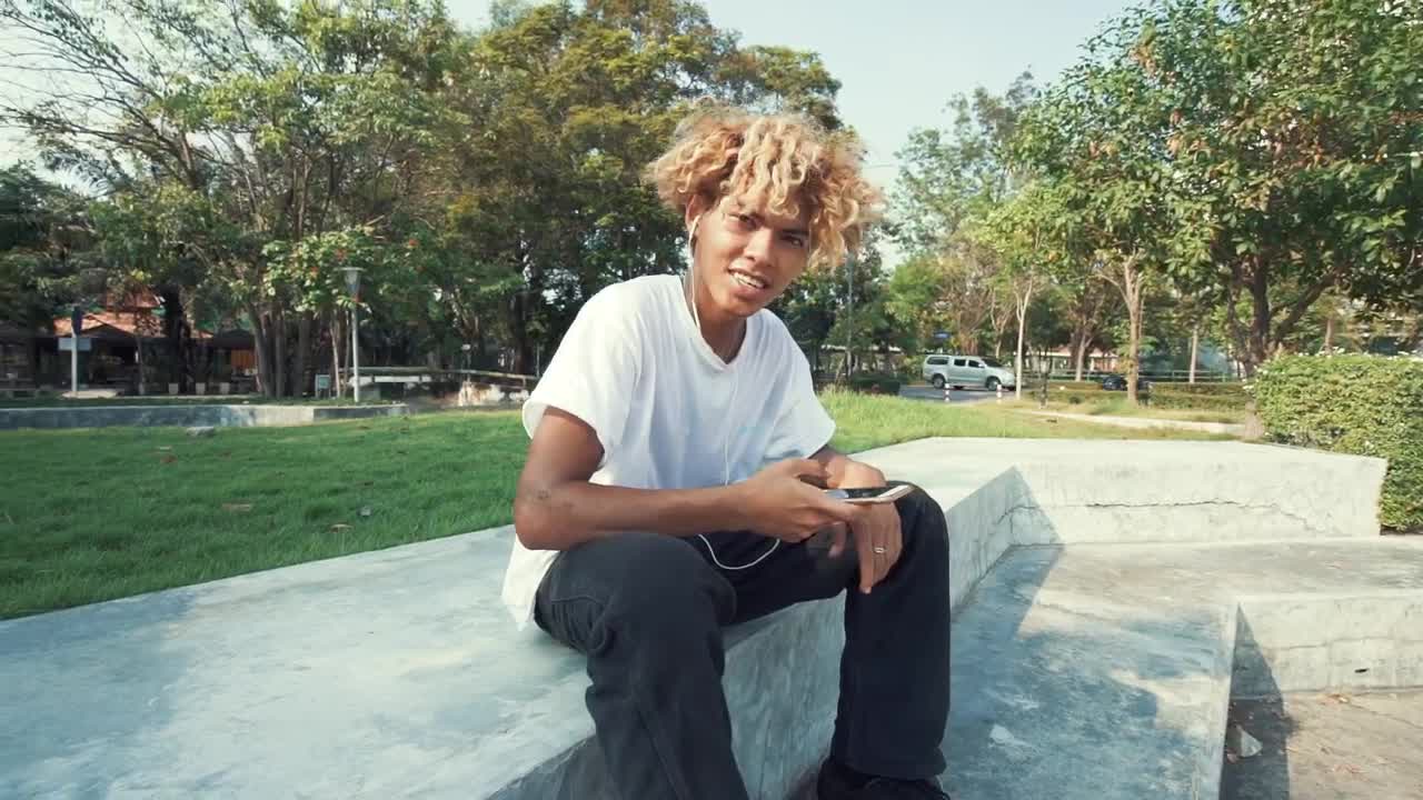 Stock Video Boy Listening To Music With Headphones In A Park Live Wallpaper For PC