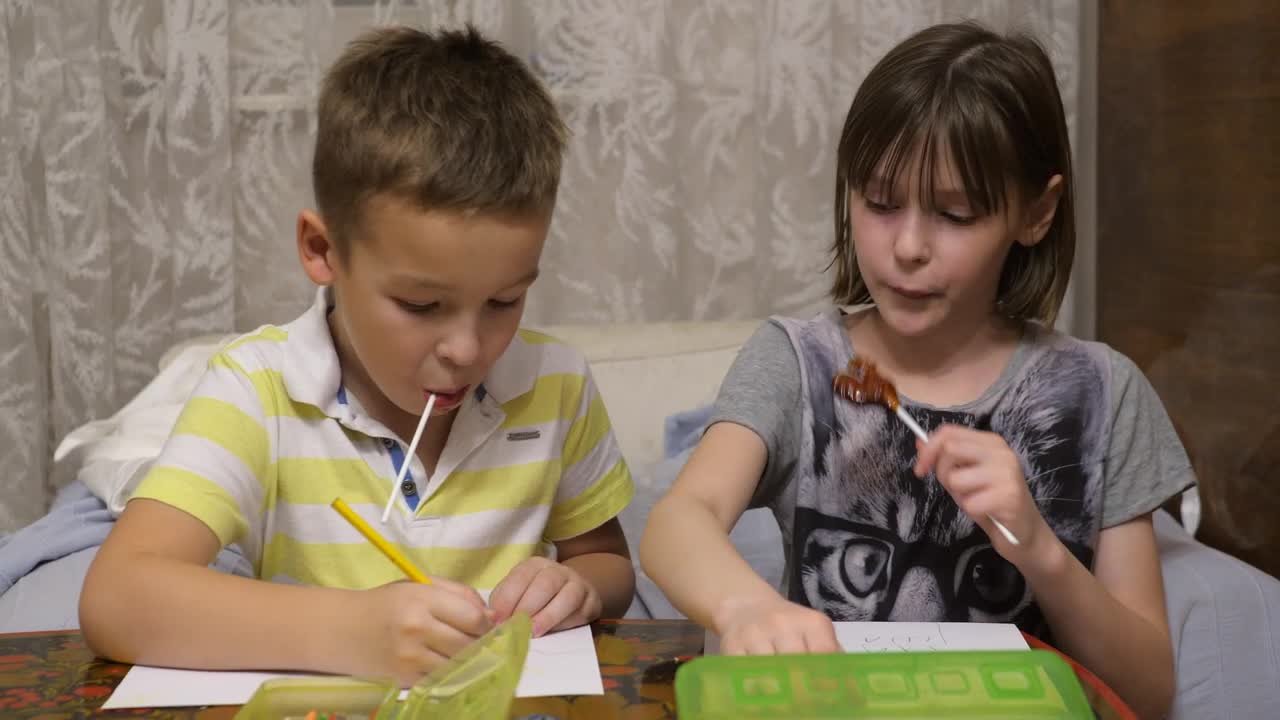 Stock Video Boy And Girl Eating Candy While Drawing Live Wallpaper For PC