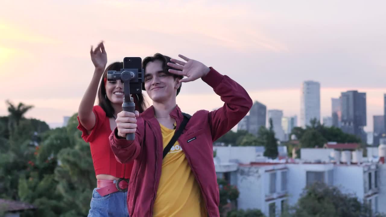 Stock Video Boy And Girl Blogging On Top With City Background Live Wallpaper For PC