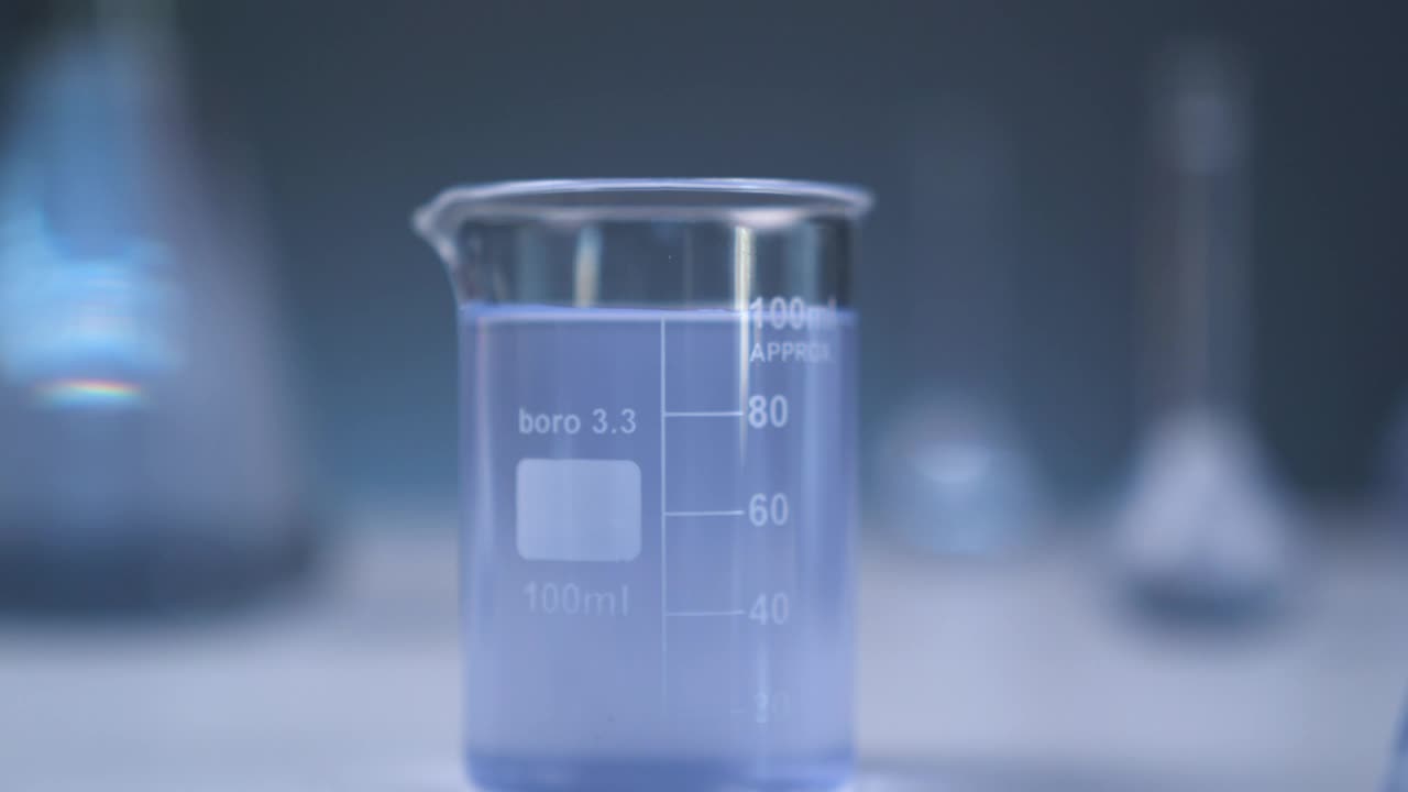 Stock Video Blue Flask Surrounded By Other Unfocused Flasks Live Wallpaper For PC