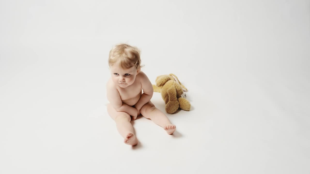 Stock Video Blonde Baby Girl Sitting In A White Background Live Wallpaper For PC