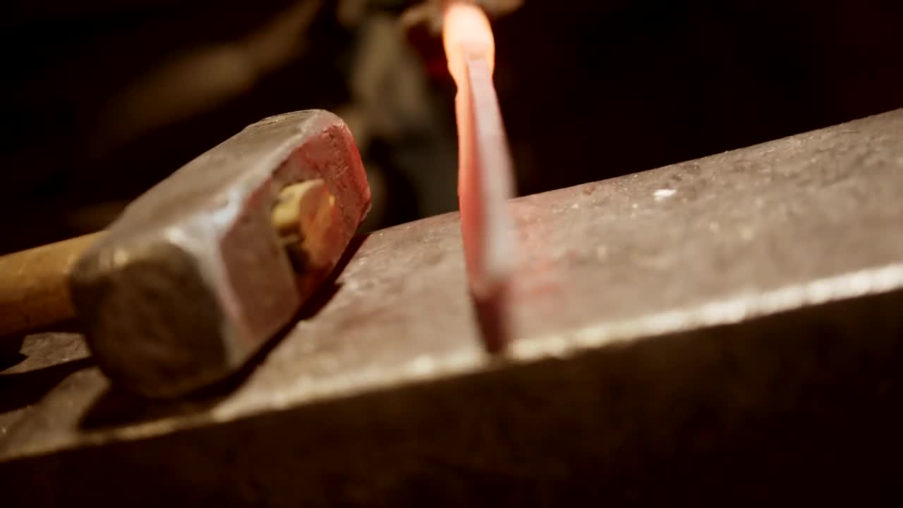 Stock Video Blacksmith Striking A Red Hot Knife With A Mallet Live Wallpaper For PC