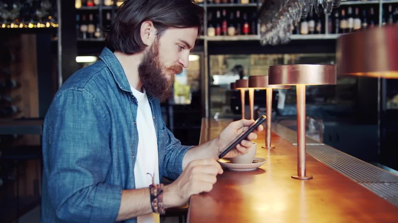 Stock Video Bearded Man Uses Mobile App In Urban Bar Live Wallpaper For PC