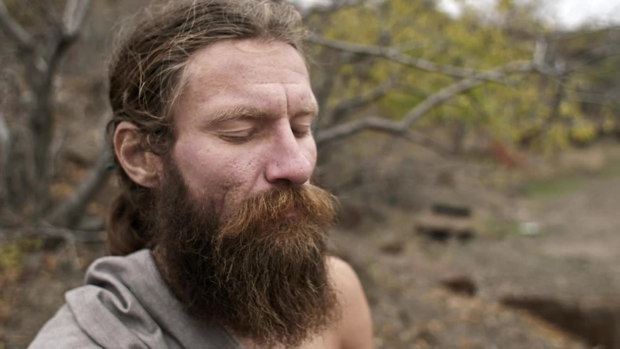 Stock Video Bearded Man Meditates With Closed Eyes In Nature Live Wallpaper For PC