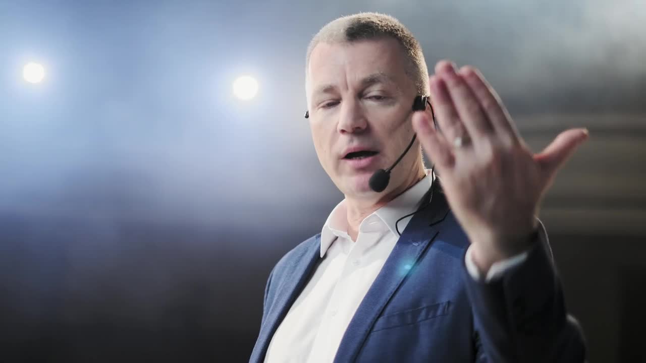 Video Stock Closeup Of Conference Speaker On Stage Gesturing At Camera Live Wallpaper For PC
