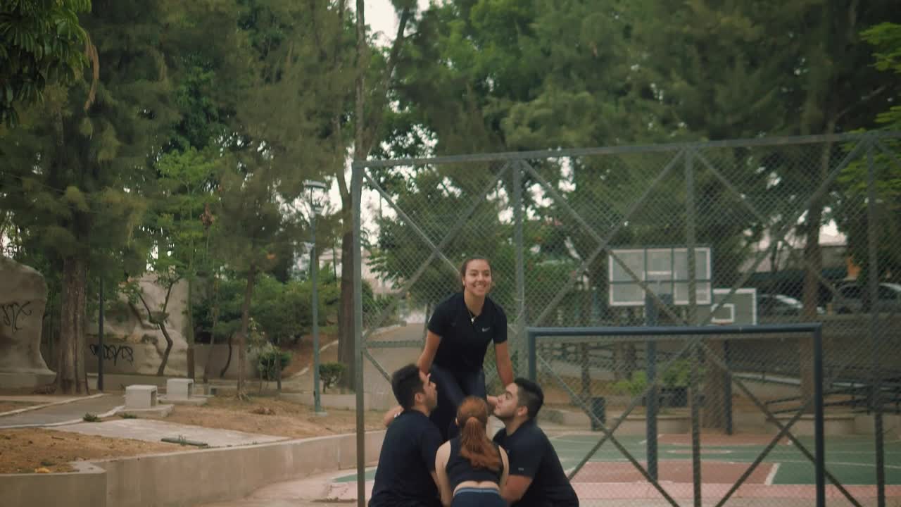 Video Stock Cheerleaders Throwing A Girl Into The Air At A Workout Live Wallpaper For PC