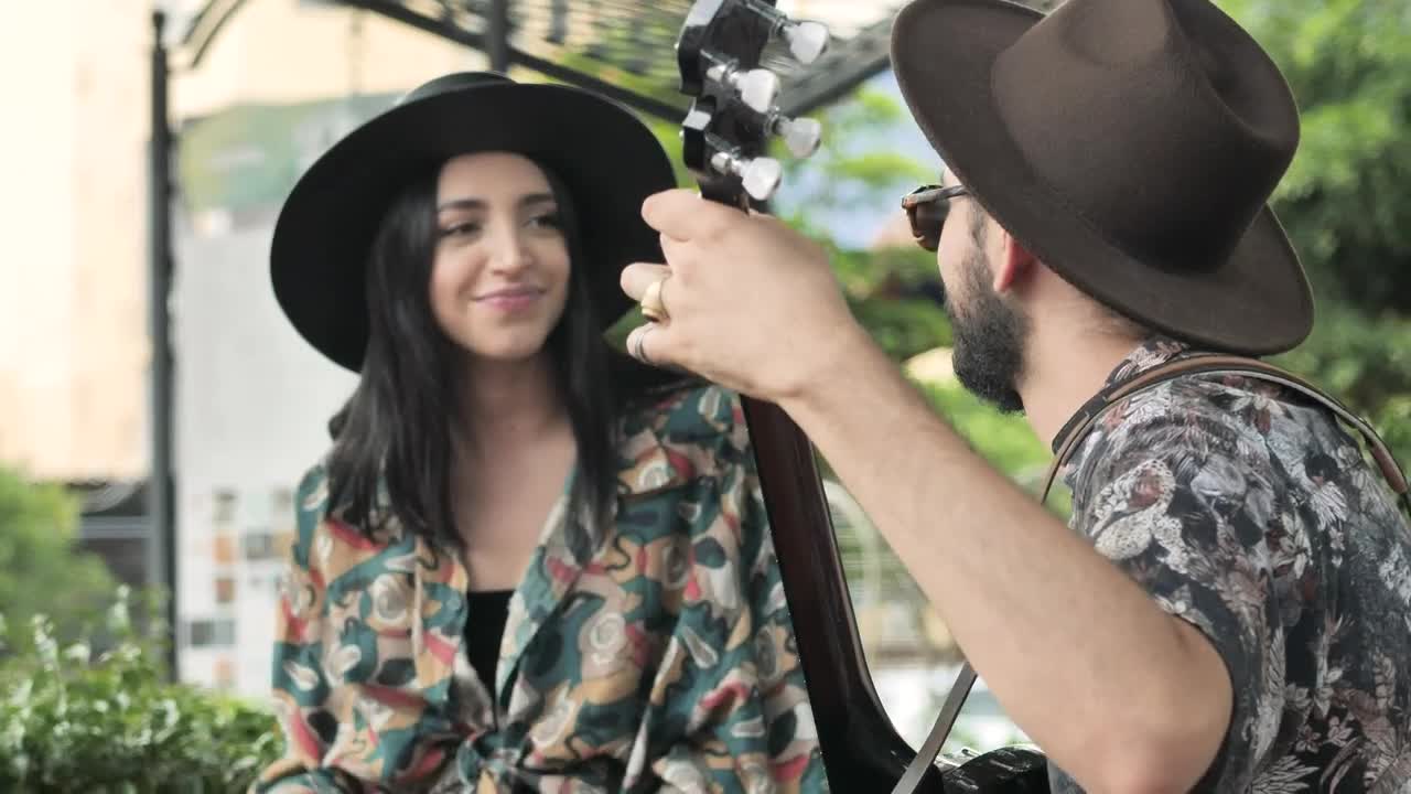 Video Stock Cheerful Boy And Girl Playing Music Sitting In A Park Live Wallpaper For PC