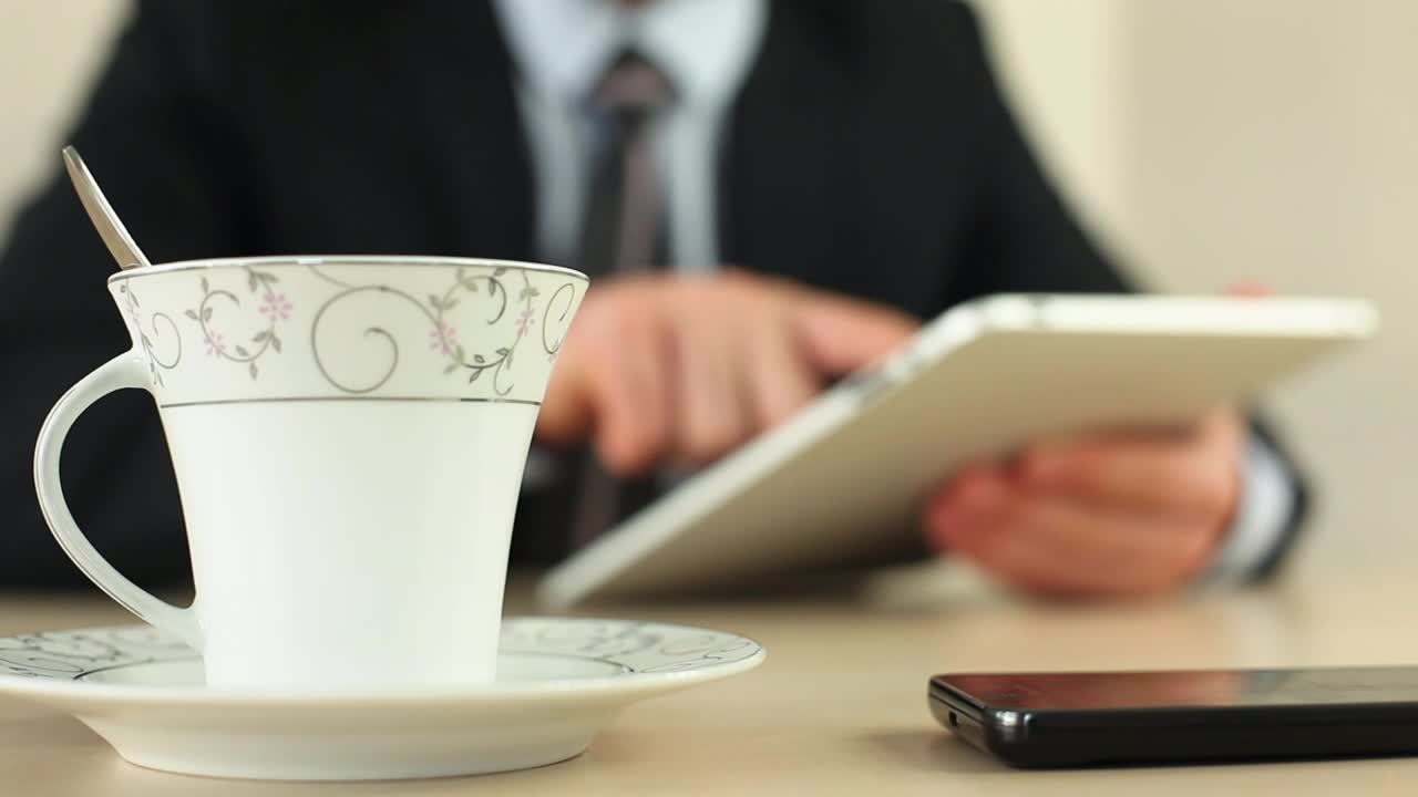 Video Stock Businessman With A Tablet Drinking Coffee Live Wallpaper For PC