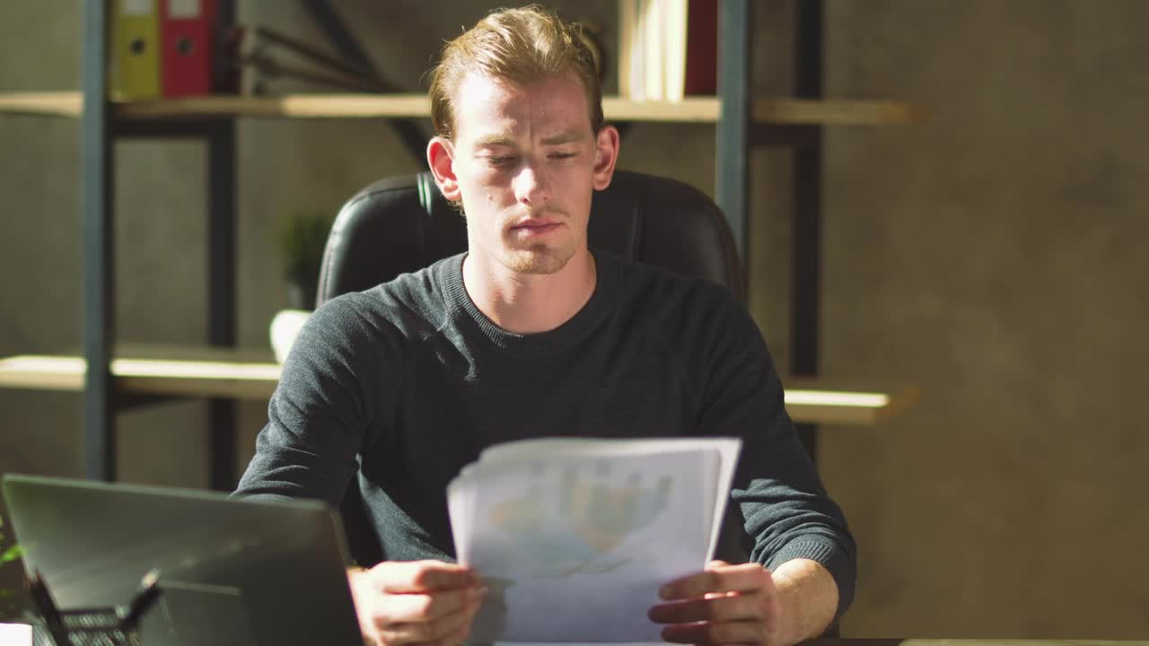 Video Stock Businessman Looks Over Finance Reports And Frowns Live Wallpaper For PC