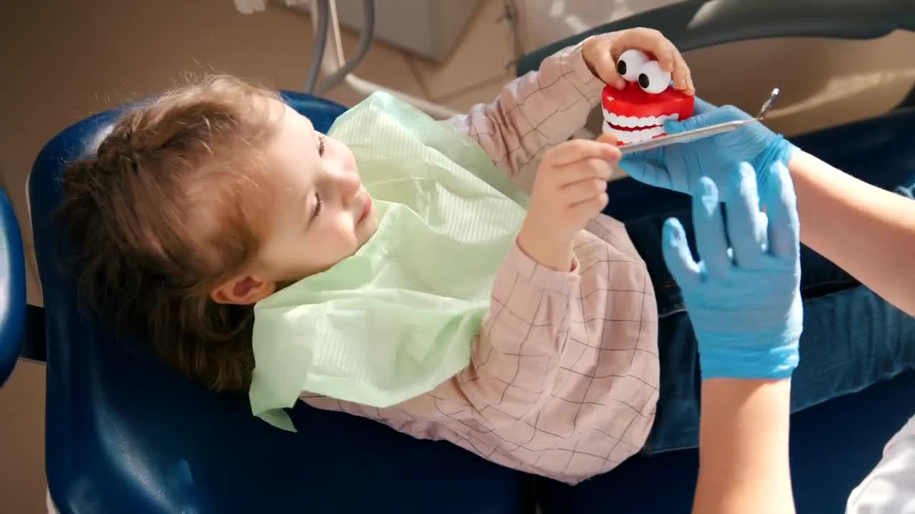Stock Video Dentist Playing With A Little Patient With A Toy Live Wallpaper For PC