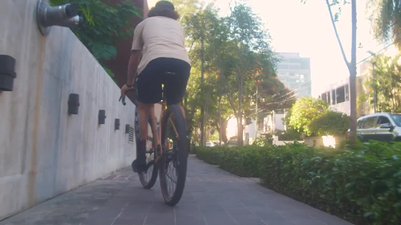 Stock Video Cyclist Zigzagging Down The Sidewalk On The Street Live Wallpaper For PC