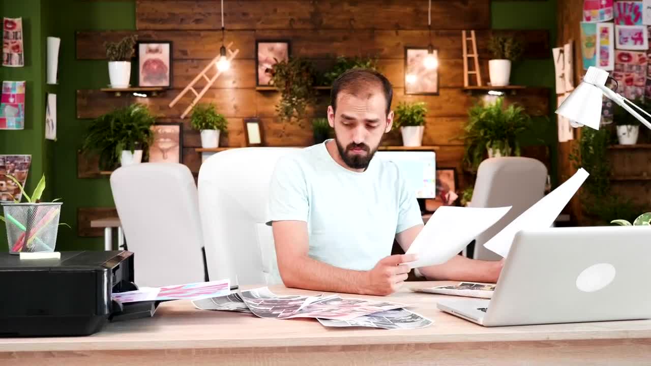 Stock Video Creative Man Prints Out Ideas In Home Office Live Wallpaper For PC