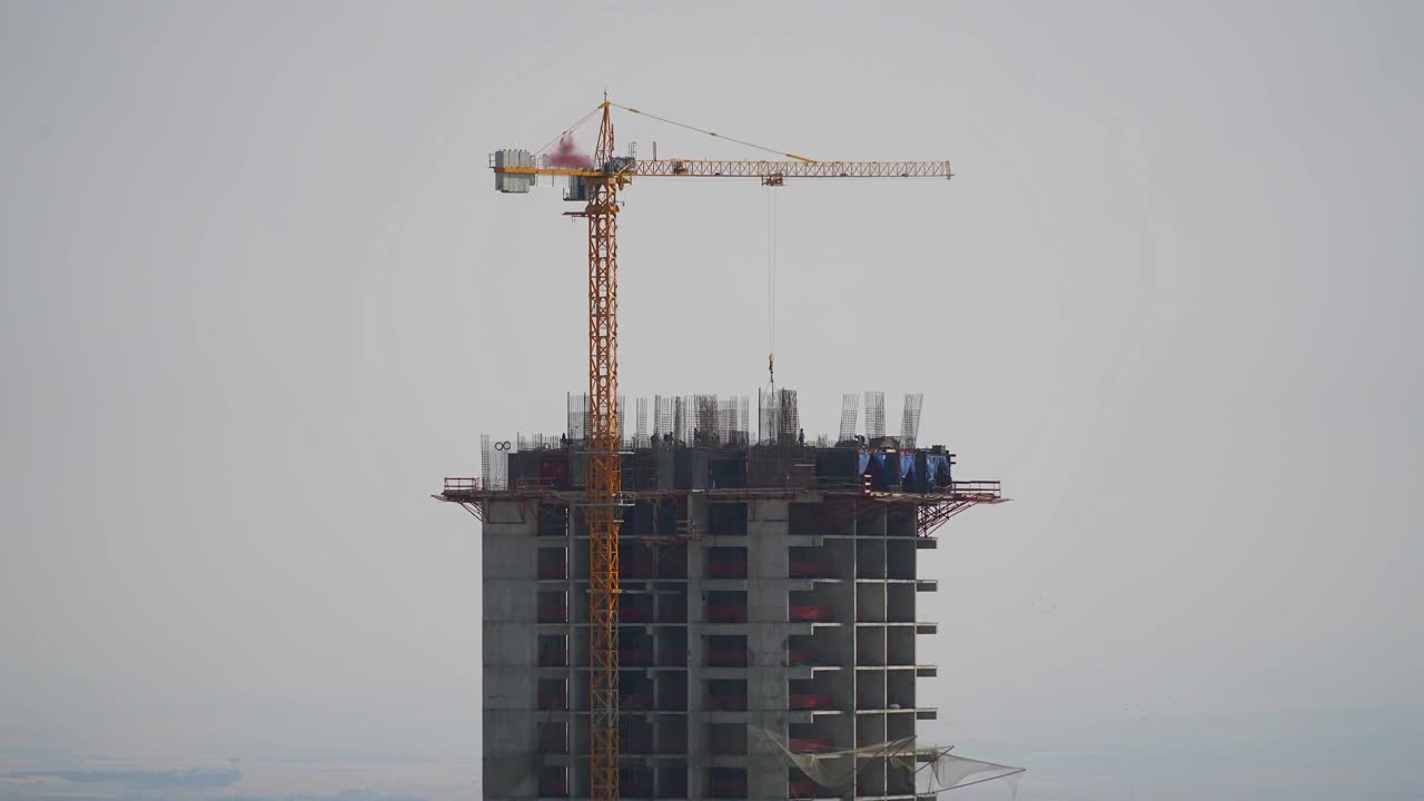 Stock Video Crane And Construction Workers At The Top Of A Building Live Wallpaper For PC