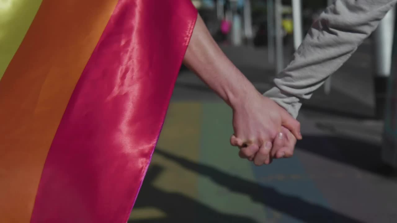 Stock Video Couple Walking In The Street With A Rainbow Flag Live Wallpaper For PC