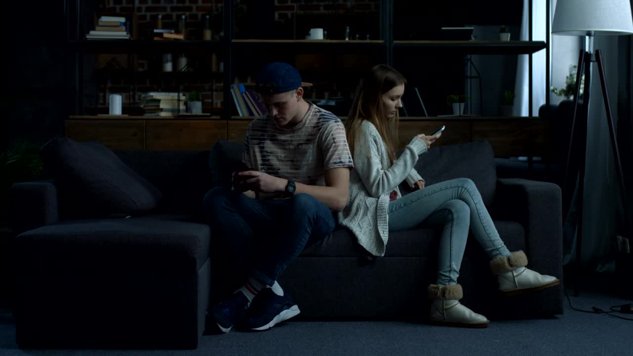 Stock Video Couple Sitting On A Sofa Back To Back Live Wallpaper For PC