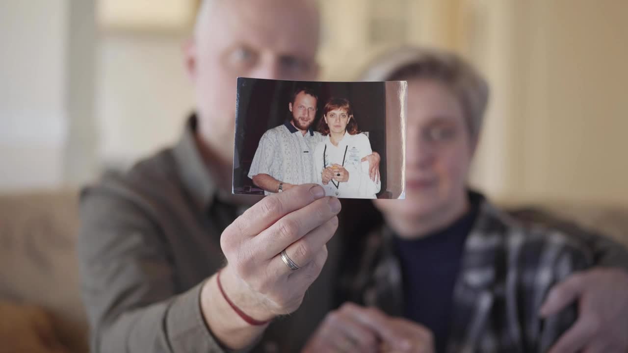Stock Video Couple Showing An Old Photograph Of Them Live Wallpaper For PC