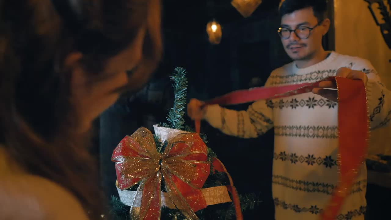 Stock Video Couple Of Man And Woman Decorating A Christmas Tree Live Wallpaper For PC