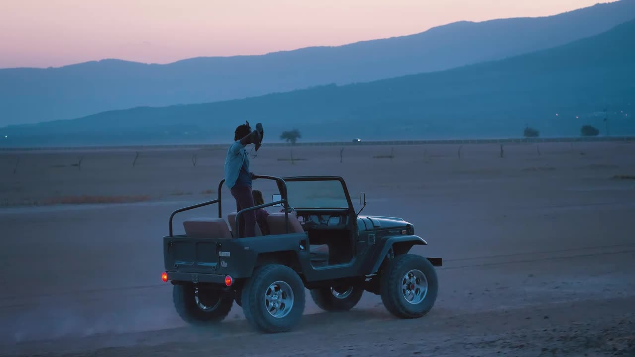 Stock Video Couple Of Friends Traveling Through A Desert On A Road Live Wallpaper For PC