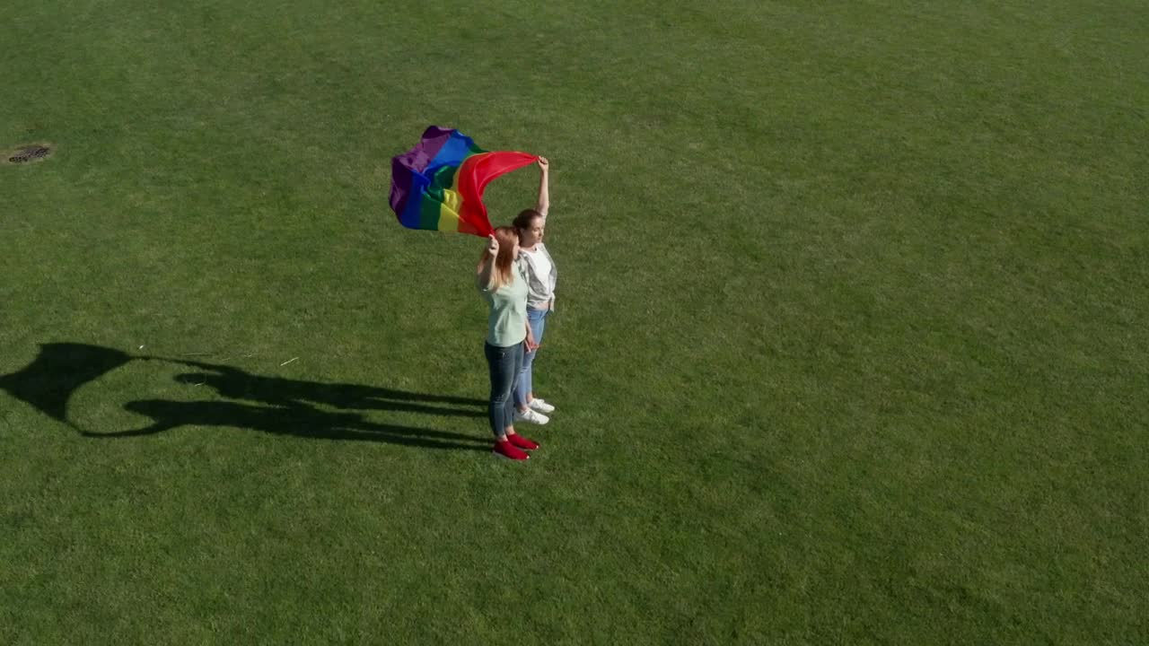 Stock Video Couple Holding A Rainbow Flag In The Wind Live Wallpaper For PC
