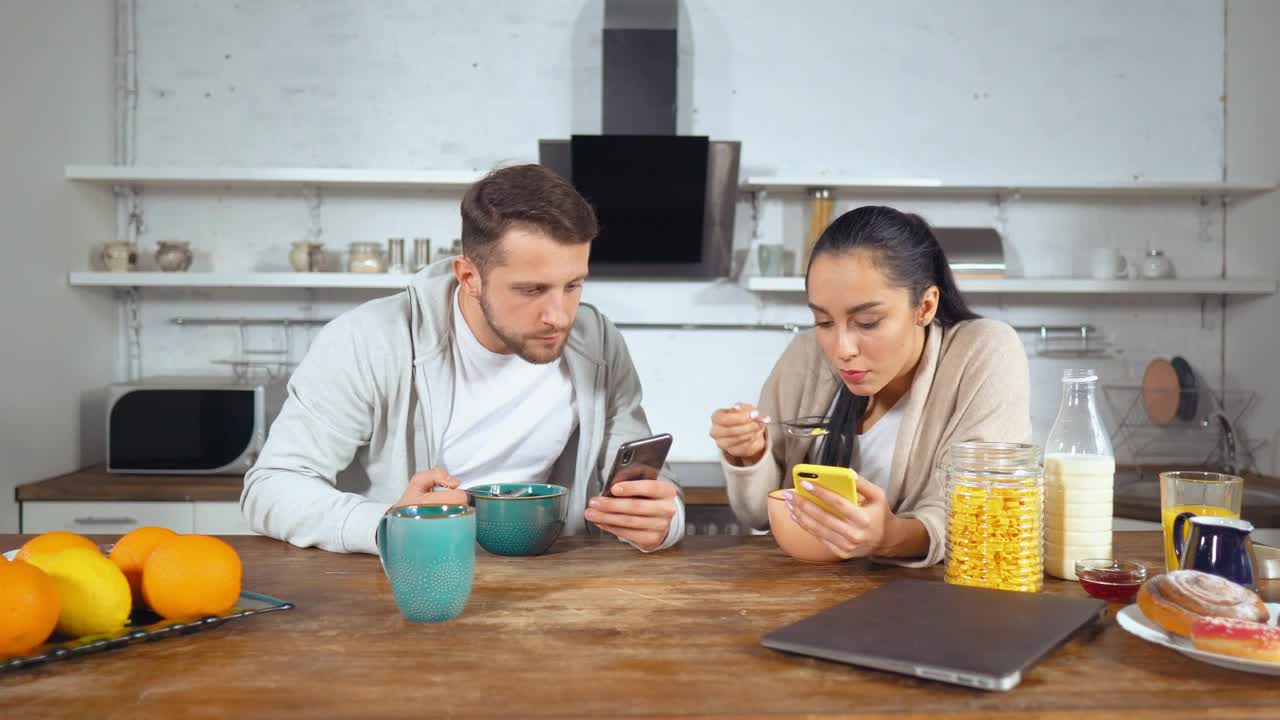 Stock Video Couple Having Breakfast Cereal And See Their Cell Phones Live Wallpaper For PC