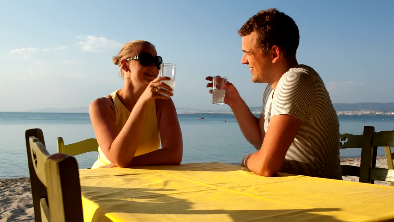 Stock Video Couple Enjoying A Drink At The Beach Live Wallpaper For PC