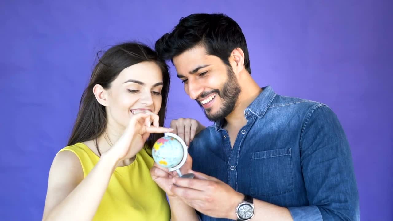Stock Video Couple Choosing A Place To Travel With A Globe Live Wallpaper For PC