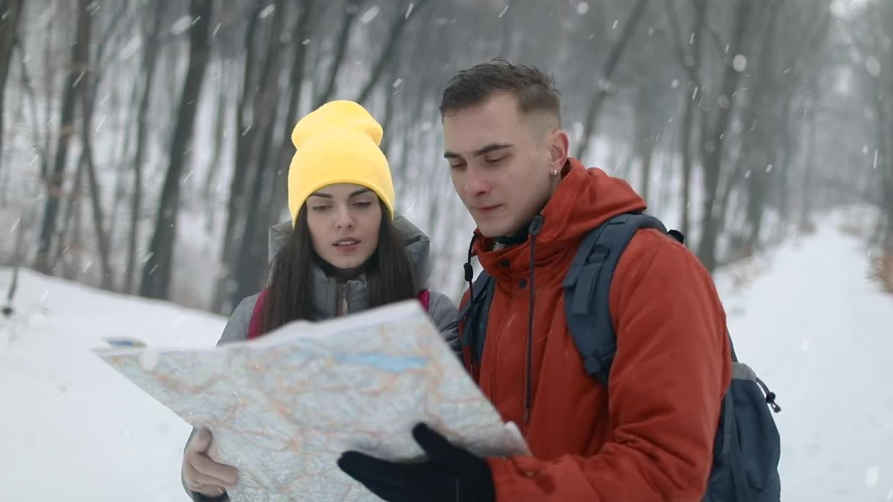 Stock Video Couple Checking Map On Hike In Snowfall Live Wallpaper For PC