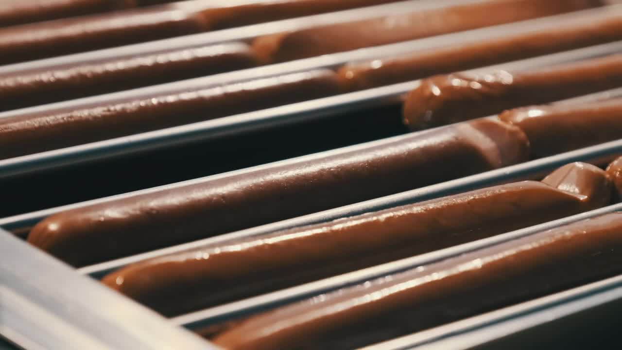 Stock Video Cooking Sausages In An Industrial Machine Live Wallpaper For PC