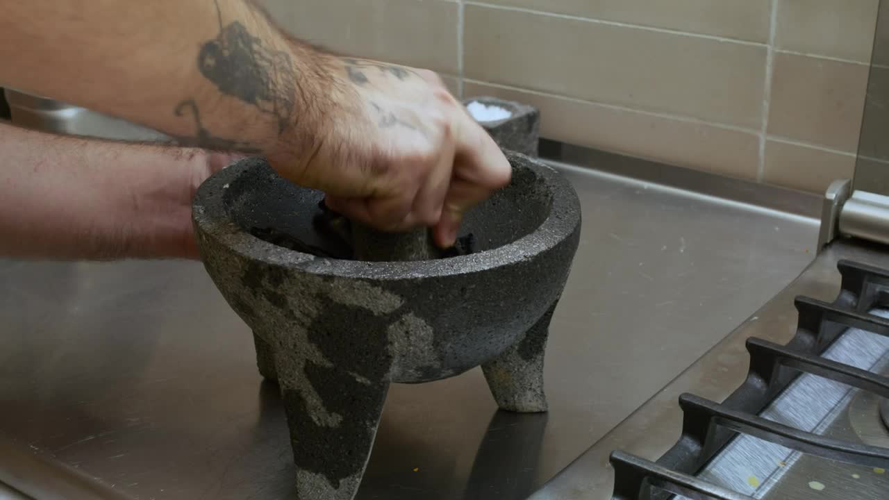 Stock Video Cook Grinding Chilies In A Molcajete Live Wallpaper For PC