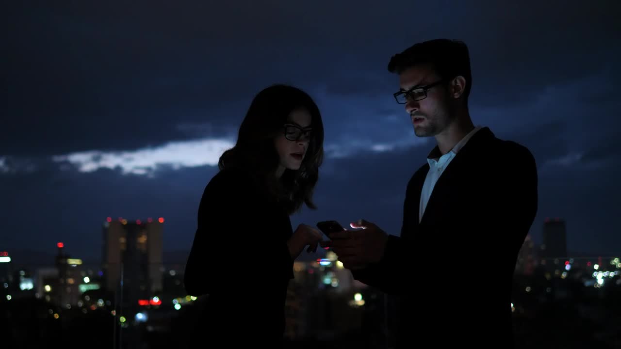 Stock Video Colleagues Looking At Information On Mobile Phone Screen Live Wallpaper For PC