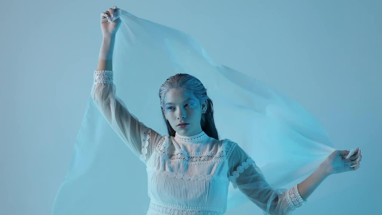 Stock Video Cold And Pale Looking Woman On A Blue Background Live Wallpaper For PC