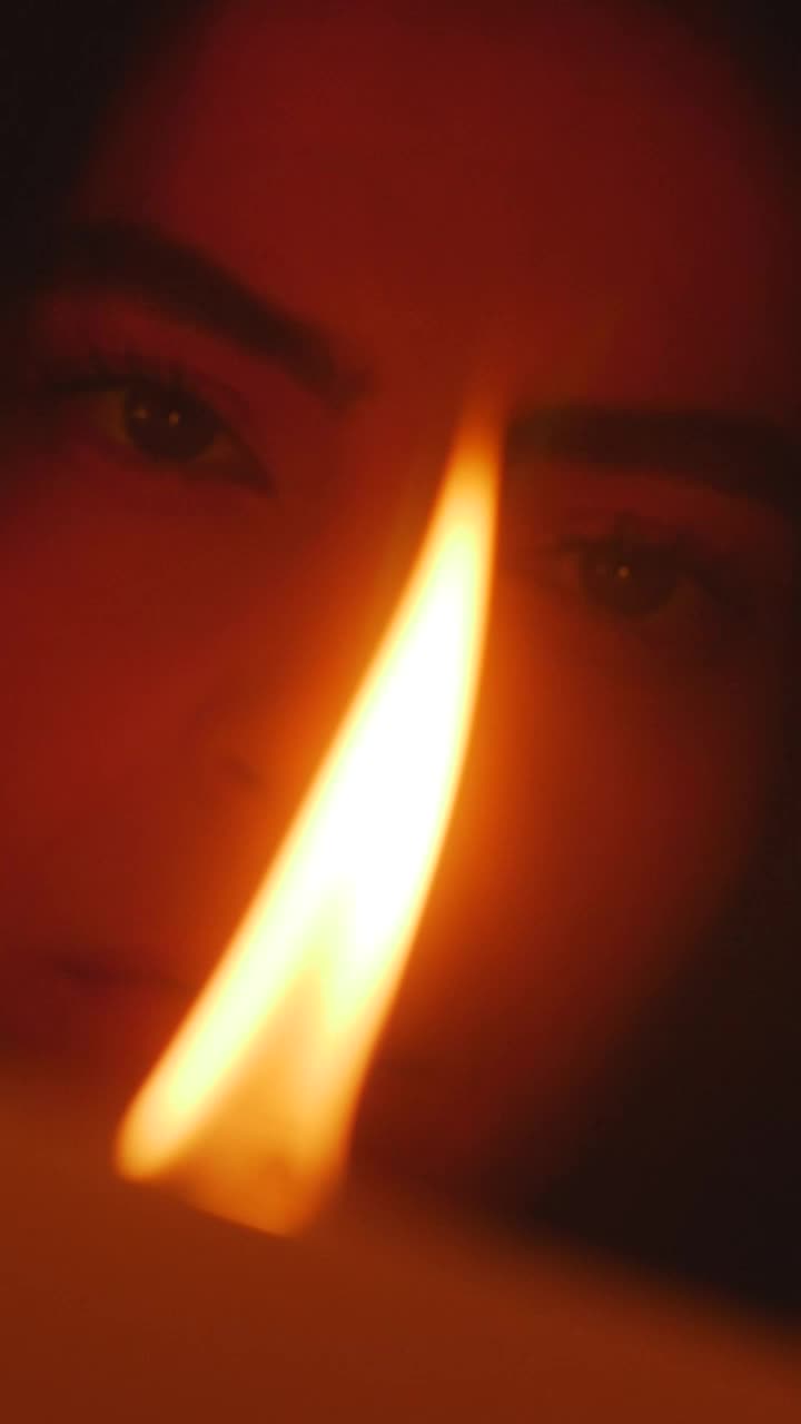 Stock Video Face Of A Young Woman Appreciating The Flame Of A Live Wallpaper For PC