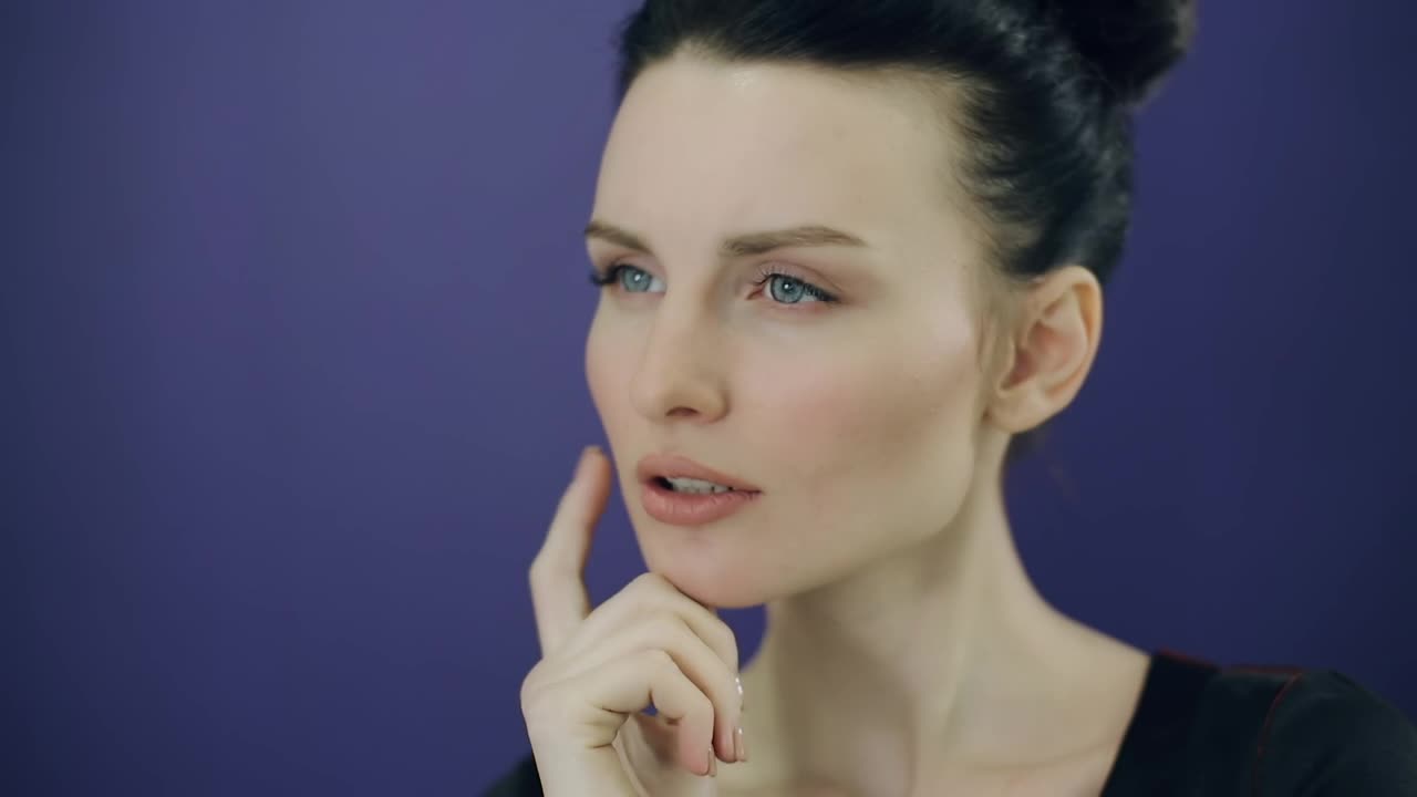 Stock Video Face Of A Young Pensive Woman On A Purple Background Live Wallpaper For PC