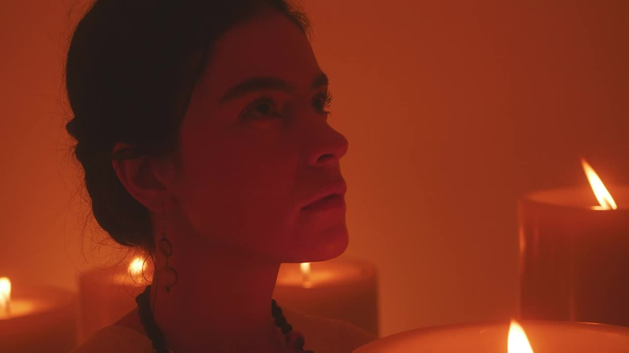 Stock Video Face Of A Spiritual Woman Meditating Among Many Candles Live Wallpaper For PC