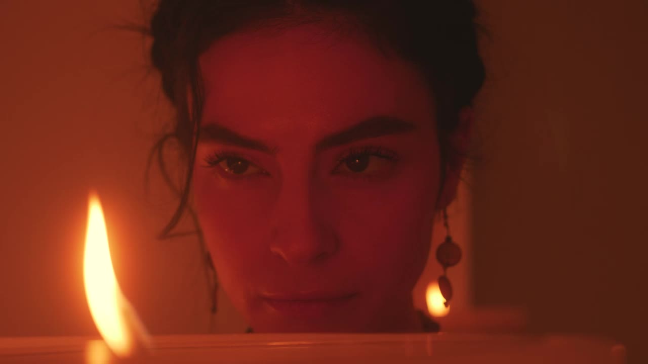 Stock Video Face Of A Spiritual Woman Looking At The Flame Of Live Wallpaper For PC