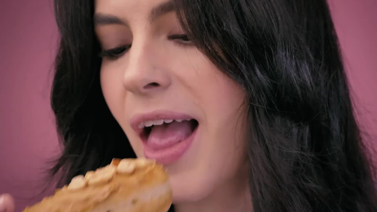 Stock Video Face Of A Girl While Biting Into A Peanut Donut Live Wallpaper For PC