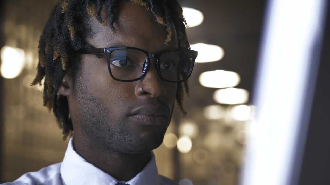 Stock Video Face Of A Concentrated Young Man In Front Of A Live Wallpaper For PC