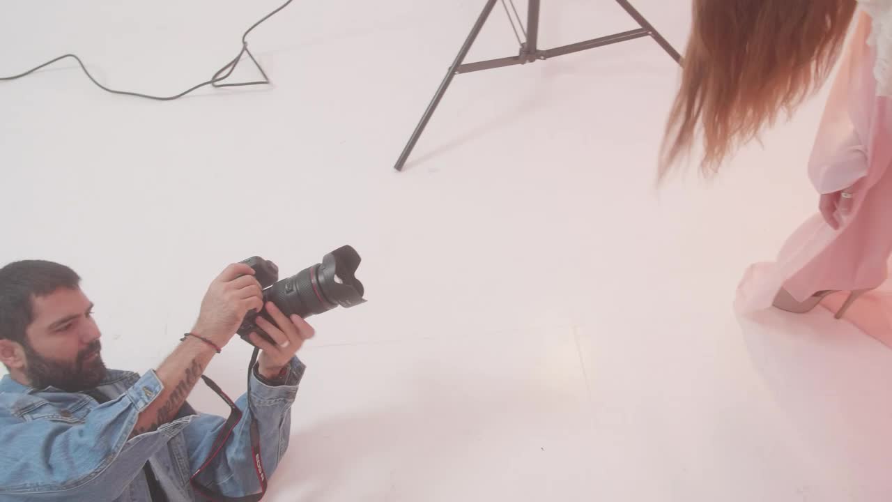 Stock Video Experienced Photographer During A Photo Shoot With A Model Live Wallpaper For PC